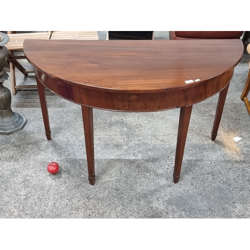 557 - A handsome Edwardian mahogany wide demilune table with four pin legs. In lovely condition from a ver... 