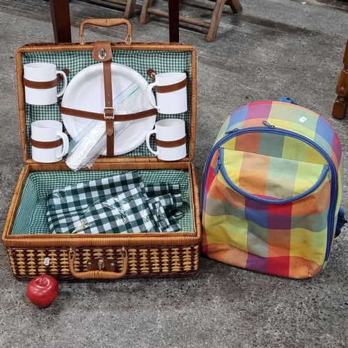 560 - A selection of picnic items comprising of a nice wicker basket with a complete plastic set of four m... 