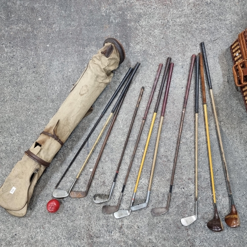 A collection of nine antique gold clubs comprising of two wood drivers ...