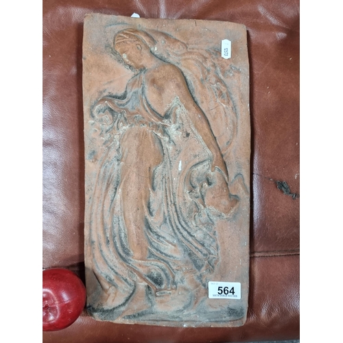 564 - A heavy solid terracotta relief plaque. Depicting a Classical female figure of a Bacchante with flow... 