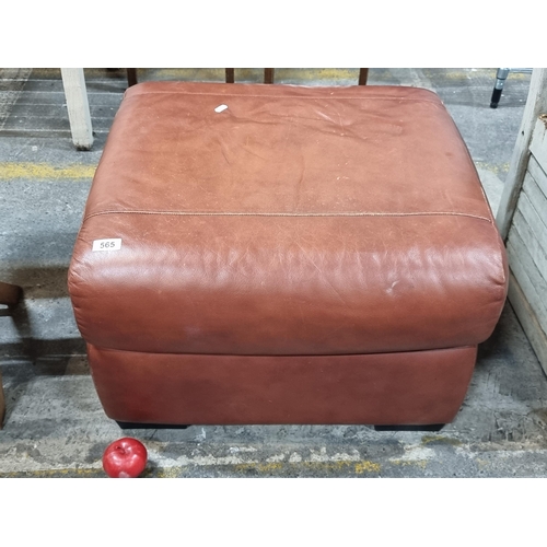 565 - A high quality genuine leather footstool. A well made example in a rich tan leather with wooden feet... 