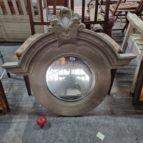 588 - A very striking circular wall mirror, with bevelled glass and heavy wooden frame featuring acanthus ... 