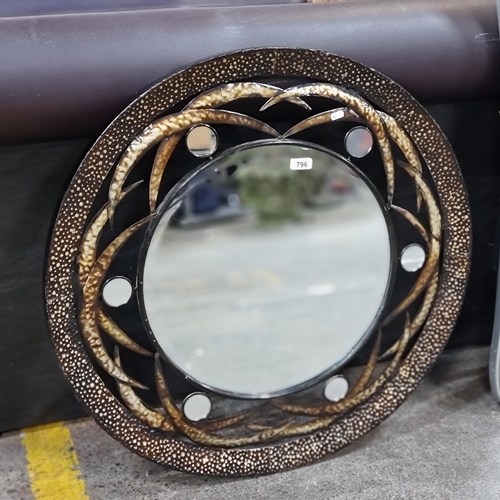 796 - A large and unusual round wall mirror with bevelled glass and an abstract metal frame with smaller m... 