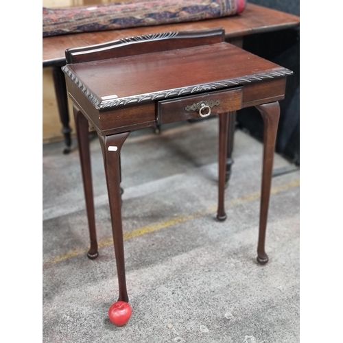 798 - A neatly proportioned hallway table with carved edge and gallery back. Featuring a drawer to front w... 