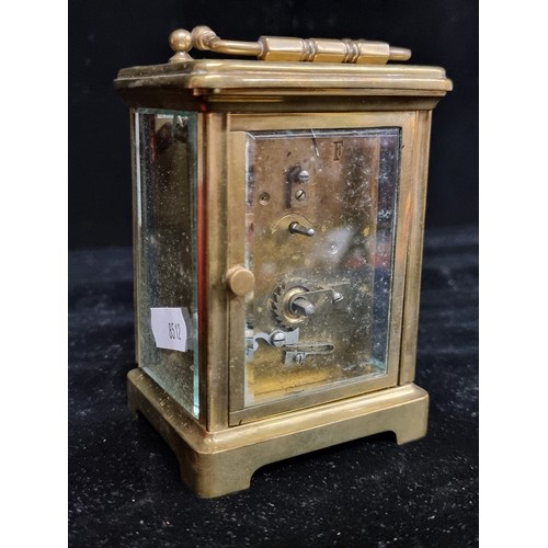 127 - A very heavy, Harrods Ltd carriage clock. Encased in thick bevelled glass with a brass case. Featuri... 