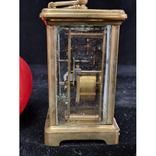 127 - A very heavy, Harrods Ltd carriage clock. Encased in thick bevelled glass with a brass case. Featuri... 