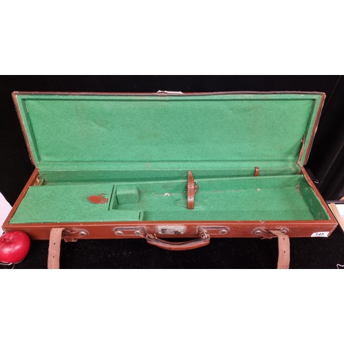 145 - A vintage, leather gun case. Decorated with a blank cartouche and green felt interior.