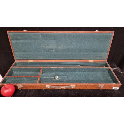 146 - A vintage wooden gun case with leather handle and green felt interior