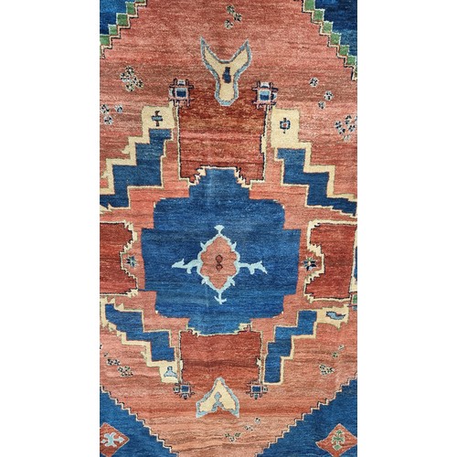 774 - Star lot : A large vintage  beautiful and heavy quality Persian wool rug in shades of orange and nav... 