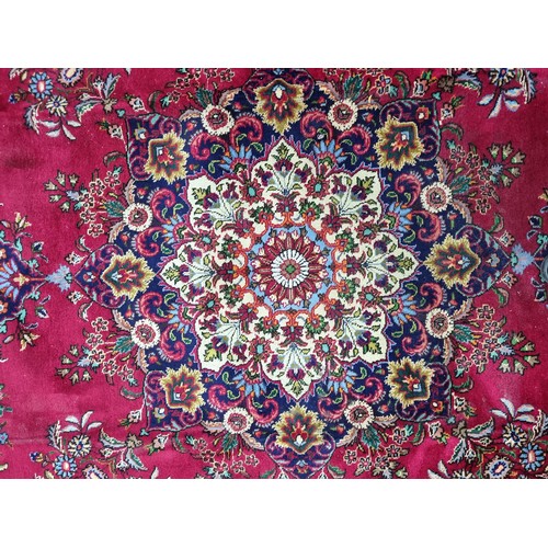 775 - Star lot : A fabulous large hand knotted wool Persian rug from the Tabriz province. In ruby shades o... 