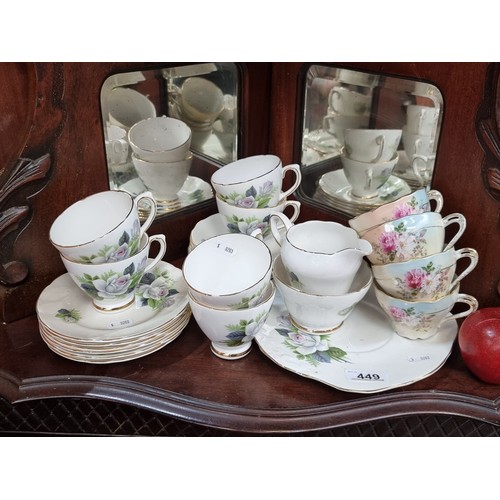 509 - A collection of twenty-one pieces of Royal Sutherland Fine Bone China, along with four delicate teac... 