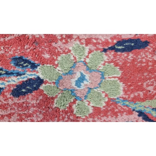 498 - Star Lot : A large Turkish wool blend rug from brand Lyric. In shades of red, turquoise and navy blu... 