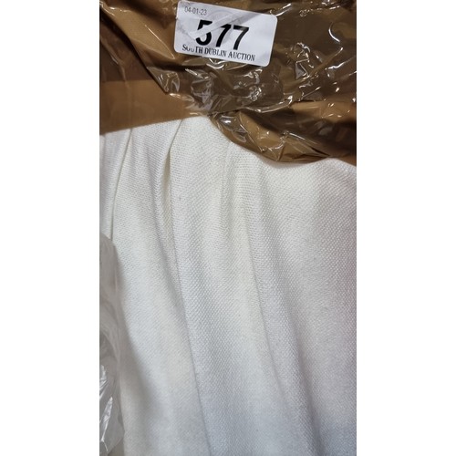 577 - A large bolt of cream synthetic fabric with slight elastic give and a satin side. Lots of value here... 