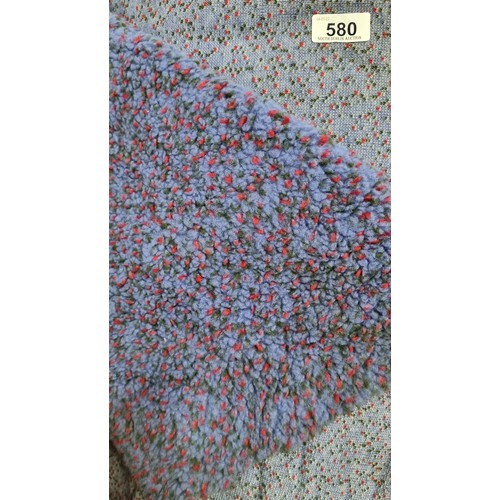 580 - A large bolt of purple fleece fabric with a thick pile and slight elastic give. Featuring red and gr... 