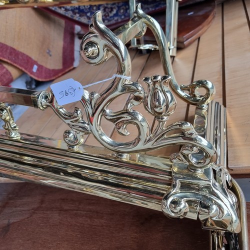 328 - Star Lot : A stunning brass fire fender featuring foliate finials and large corner detail. Internal ... 