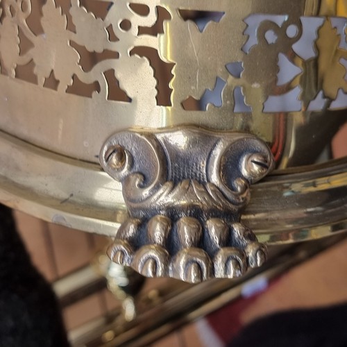 329 - A gorgeous brass fender with rounded corners, pierced foliate detail and lion paw feet. W124cm x D32... 