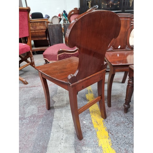 358 - Star Lot : A pair of beautiful mahogany Victorian hall chairs with scroll motifs. Its stunning condi... 