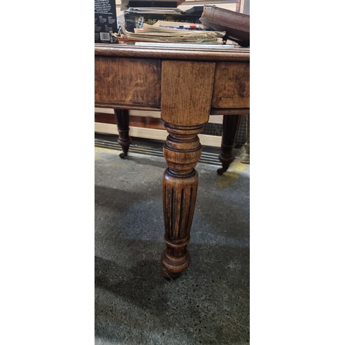 684 - Star Lot : A fabulous and unusual Victorian oak dining table of oval form. Carved from oak with heav... 