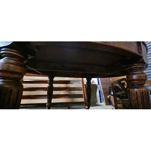 684 - Star Lot : A fabulous and unusual Victorian oak dining table of oval form. Carved from oak with heav... 