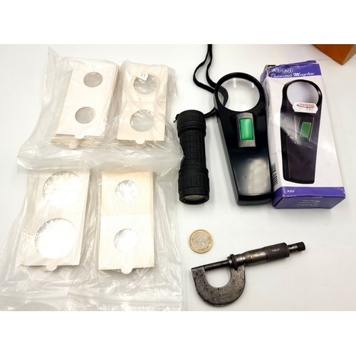 410 - Three items including a new Magnifying glass with light a micrometer and tow sizes of  cardboard coi... 