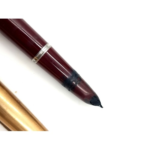 426 - Three Parker pens inc a vintage gold toned topped fountain pen and a ballpoint cross refill.