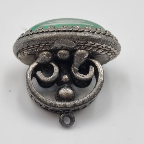 439 - An antique jade stone fob seal  with foliate surround mount together with a pair of Irish 1967 coin ... 