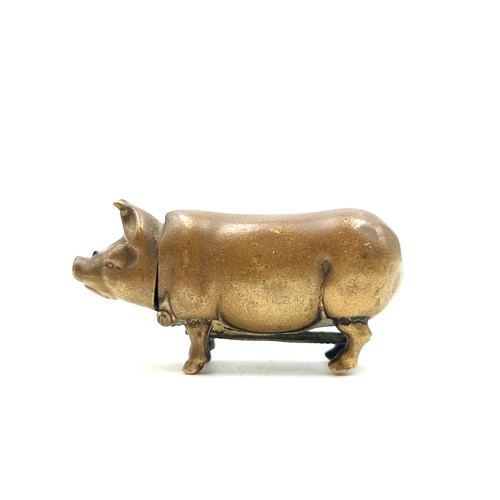 720 - A nice example of a Victorian brass vesta case in the form of a pig. 
Weight: 14.57 grams the Head l... 