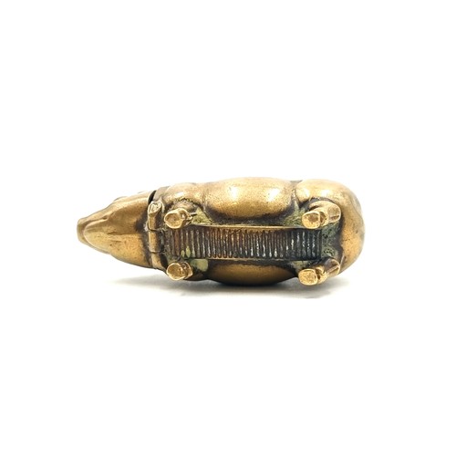 720 - A nice example of a Victorian brass vesta case in the form of a pig. 
Weight: 14.57 grams the Head l... 