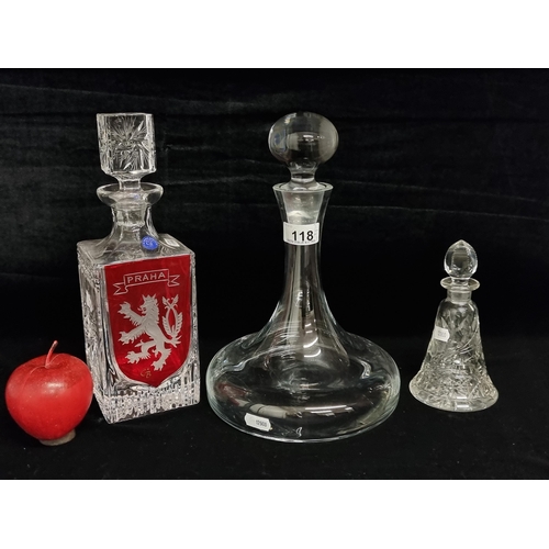 118 - A selection of three elegant cut crystal and glass decanters in varying sizes and shapes. Including ... 