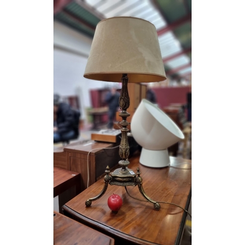 483 - A heavy quality ornate table lamp with a brass base featuring profuse foliate design throughout and ... 