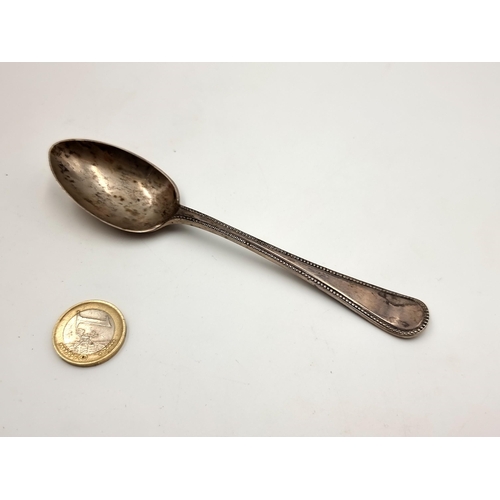 60 - An attractive antique fiddle motif sterling silver desert spoon, with a dragoon detailing. Hallmarke... 