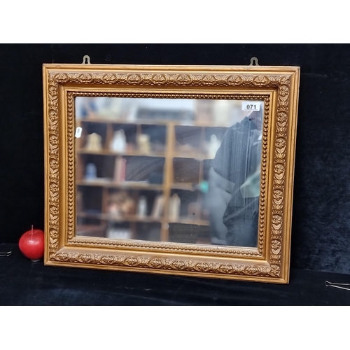 71 - A nicely proportioned rectangular wall mirror with carved wooden frame and gilt finish.