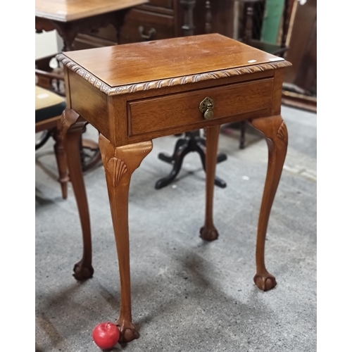 771 - An elegant vintage hallway table with carved edge, brass drop handle and claw and ball feet. H75cm x... 