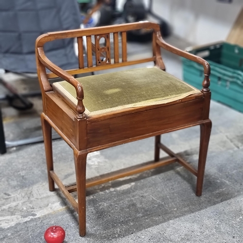 772 - A beautiful vintage sewing bench with a pierced splatback and ample storage under lid. The padded se... 