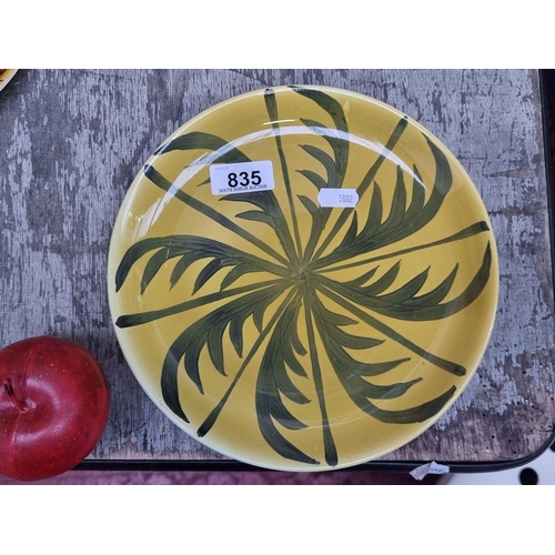 835 - A gorgeous John Ffrench Arklow Studio Pottery plate with palm leaf motif in a mustard glaze, signed ... 