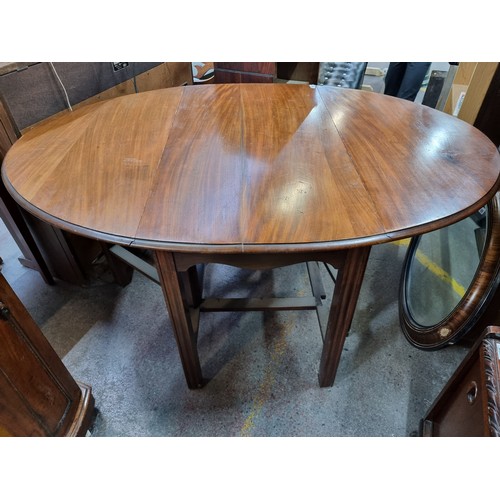 485 - A very handsome Edwardian gate-leg drop-leaf table. Crafted from  flame mahogany wood, with reeded l... 