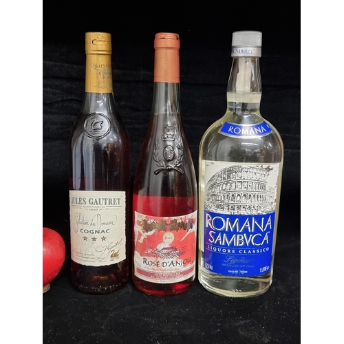 132 - Three sealed bottles of alcoholic beverages including a 70 cl Jules Gautret cognac, a 2003 75 cl ros... 