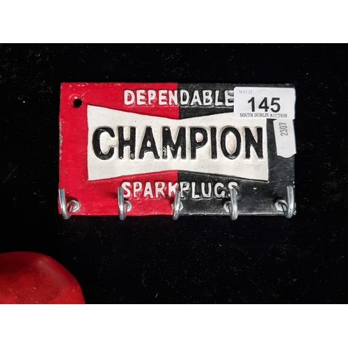 145 - A cast metal, key rack advertising Champion Spark Plugs. Hand painted in the company colours.