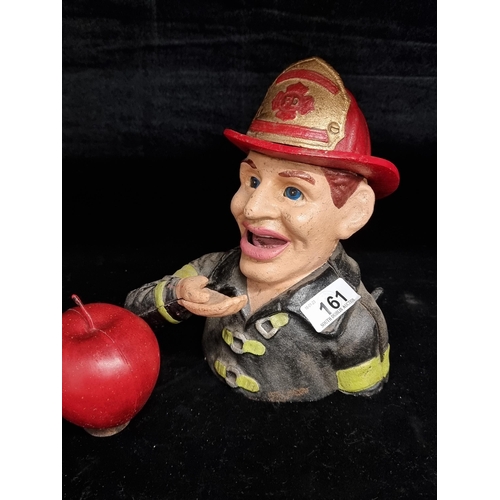 161 - A heavy cast metal, articulated money box in the form of a NY Fireman. Featuring mechanised arm, ton... 