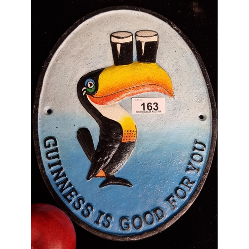 163 - A cast metal advertising plaque for Guinness. Designed in an oval shape with iconic Guinness toucan ... 