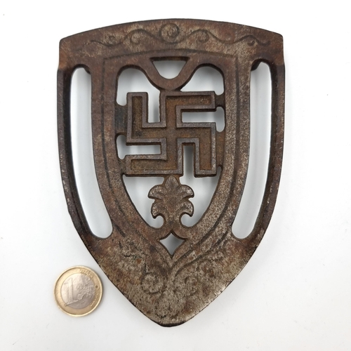 2 - An original WWII German raised cast iron Trivet, depicting a large WWII shield with a scroll border ... 