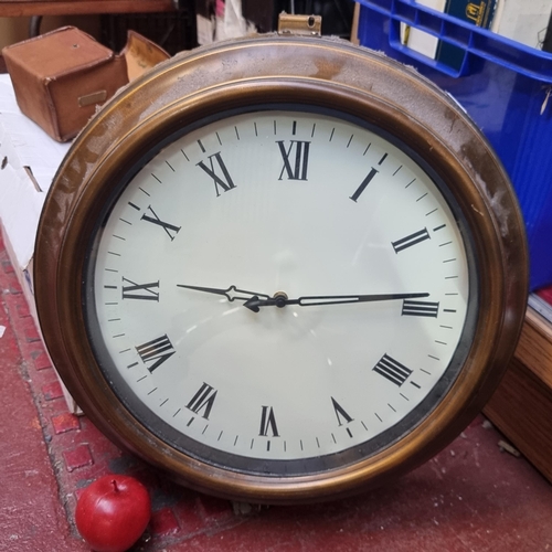 288 - A double sided wall clock in the form of a vintage railway station clock. Featuring brass toned beze... 