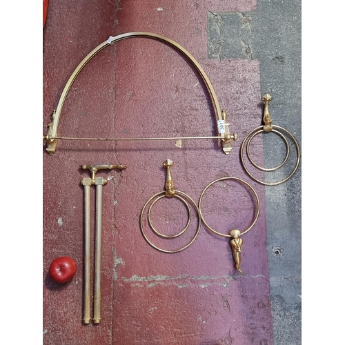 301 - A selection of brass bathroom rails in the Regency style. Including three towel rings with mermaid m... 