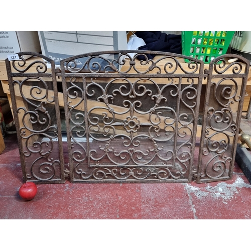 331 - A very heavy cast iron fire guard with lovely curvilinear scroll design.