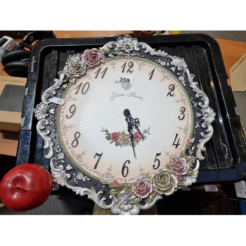 359 - A decorative large vintage quartz wall clock with ornate floral design.