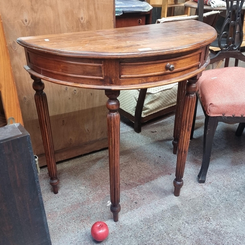 388 - A handsome Victorian demilune table with a neatly proportioned drawer to front and four reeded legs.... 