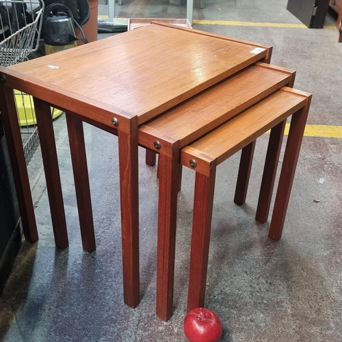 394 - A well proportioned set of three teak mid century modern nesting tables. In nice condition.  Very ni... 