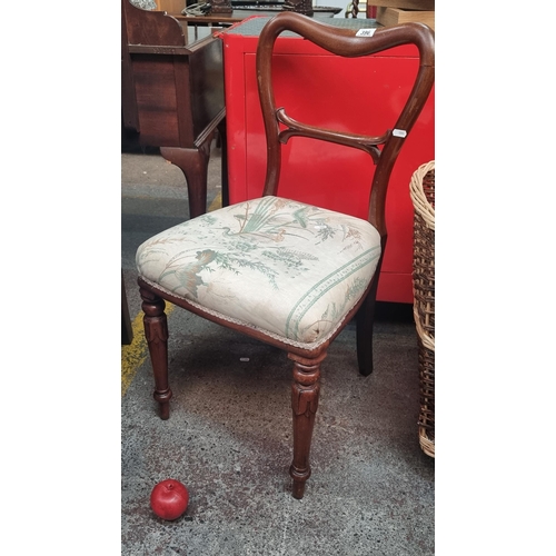 396 - A beautiful Victorian occasional chair with turned legs and a padded seat upholstered in flora and f... 