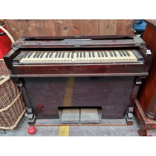 400 - An antique portable piano housed in a glossy wooden case and complete with all keys. With foldable t... 