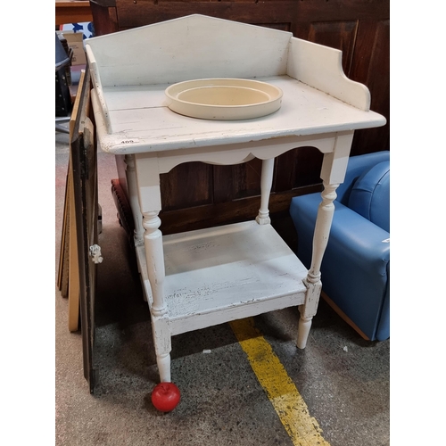 409 - An antique wash basin stand with a gallery back, a shelf to base and accompanied by a ceramic Burlei... 